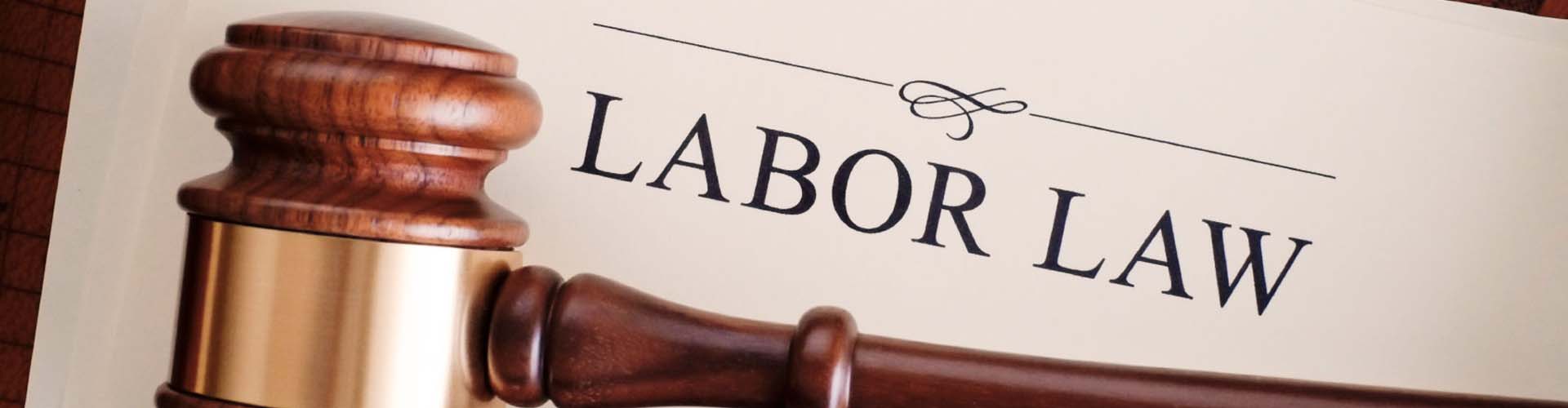 Labor law printed on paper in front of judges gavel